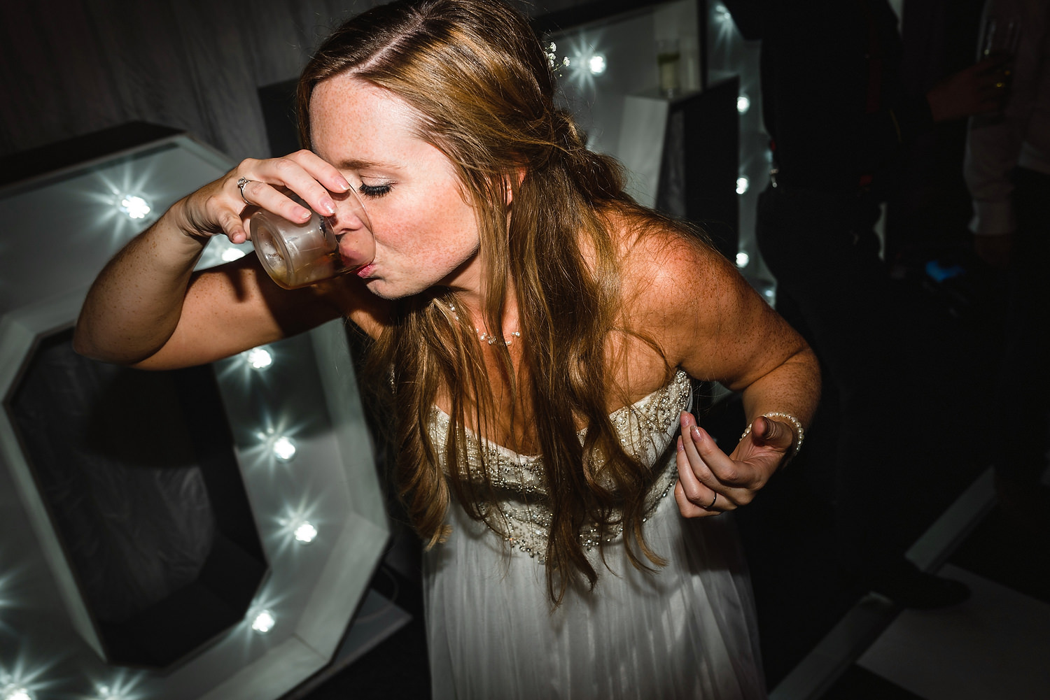 bride drinking on dancefloor