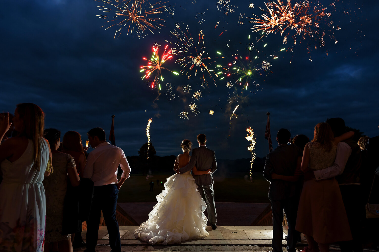 bride and grom watching fireworks at lulworth castle wedding