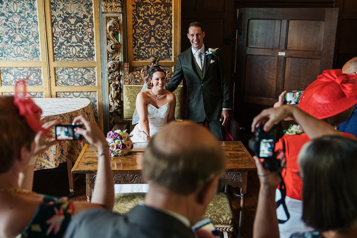 bride and groom signing register at ramster hall