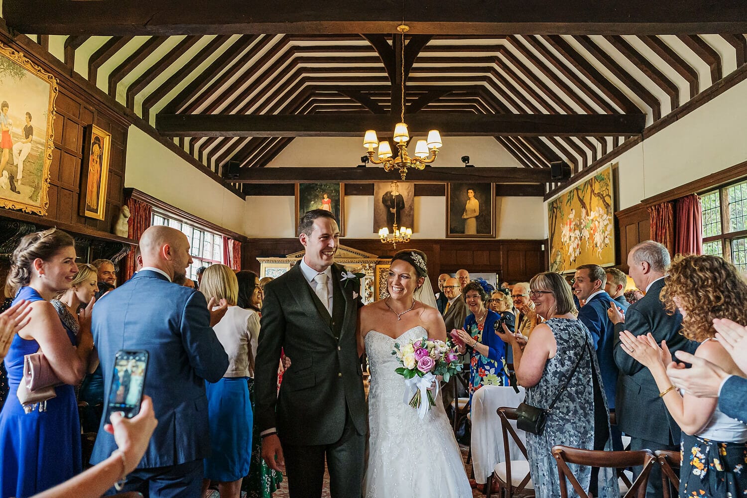 bride and groom walking down aisle at ramster hall